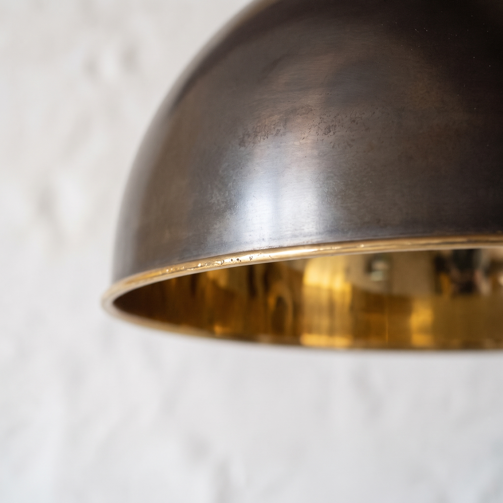 Close-up of the antique bronze outside meeting the polished brass interior at the rim