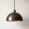 Smooth antique bronze dome pendant light with polished brass interior