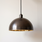Smooth antique bronze dome pendant light with polished brass interior