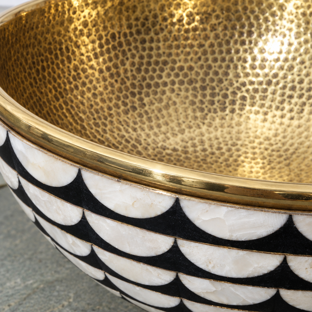 Close-up of the black and white scallop brass vessel sink showing the finish