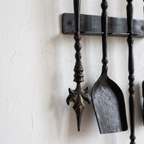 Close-up of the leaf-shaped poker tip and twisted handles in dark black brass