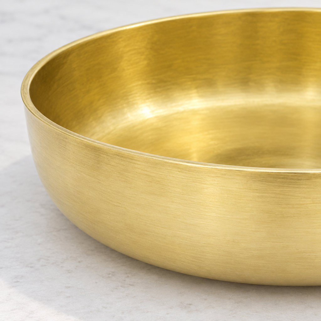 Close-up of the brushed brass surface and thin rounded rim