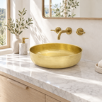 Bright California powder room with a brushed brass round vessel sink