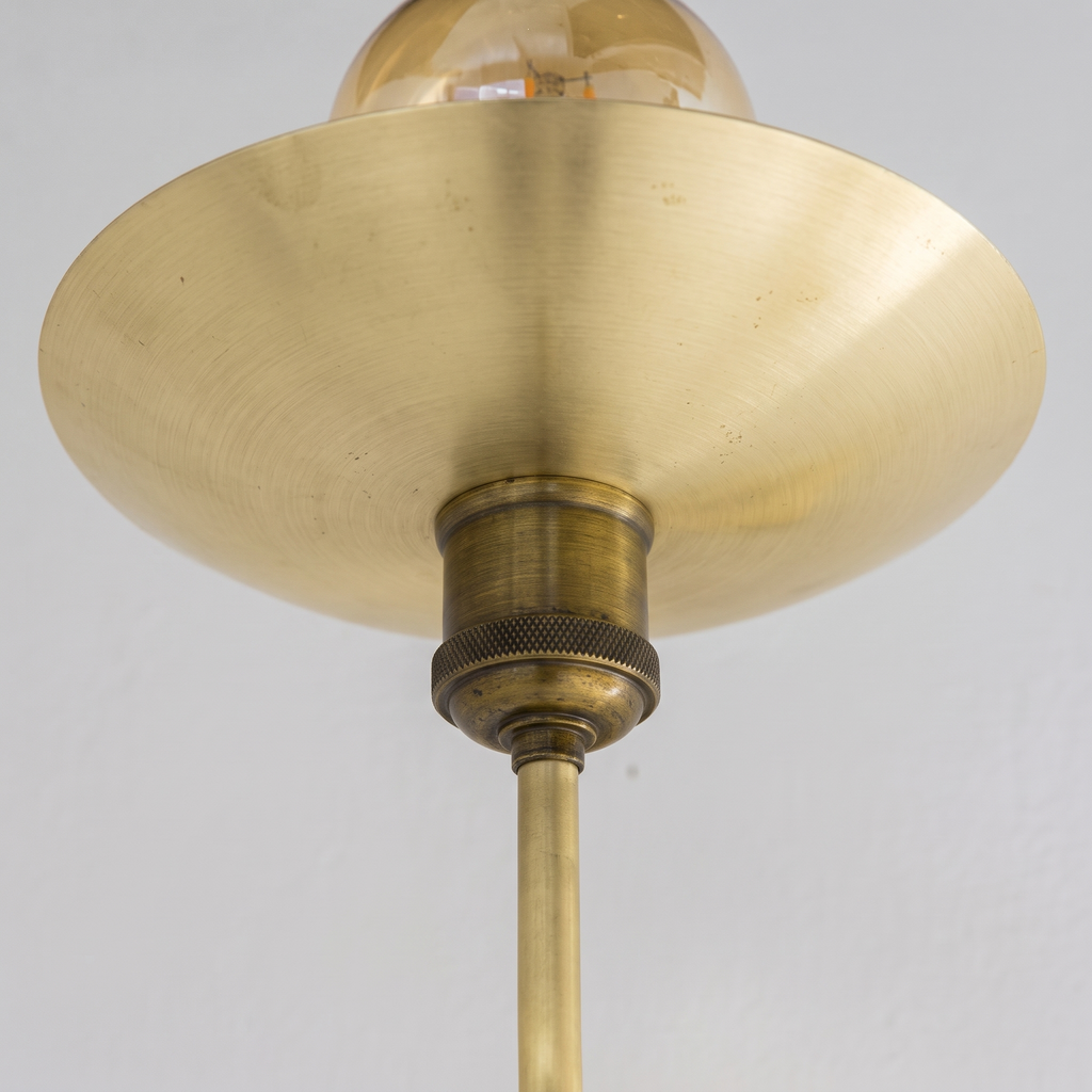 Close-up of the brushed brass saucer dish and knurled antique brass socket