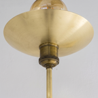 Close-up of the brushed brass saucer dish and knurled antique brass socket