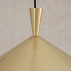 Tapered neck and brushed finish of the brass cone pendant