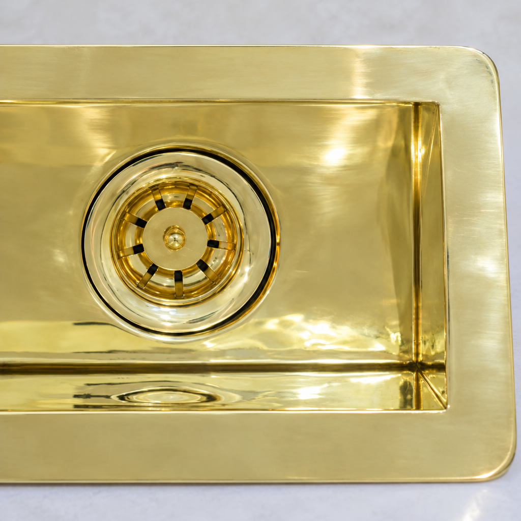 Close-up of the brass basket strainer and polished brass flange