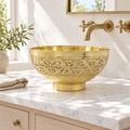 Engraved Brass Pedestal Vessel Sink installed in a bright bathroom