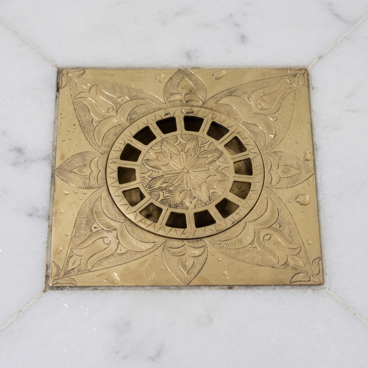 Close view of the engraved floral grate centre and slots