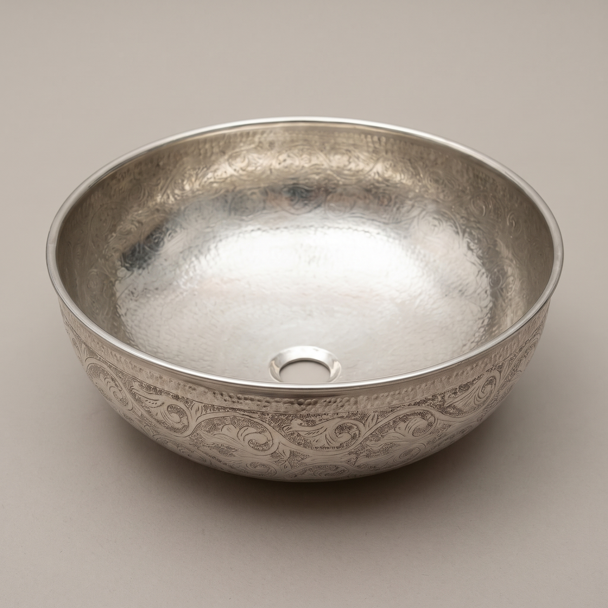 Round German silver vessel bowl with engraved vine pattern outside on a plain background