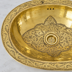 Close-up of the engraved floral rim and arabesque drain medallion