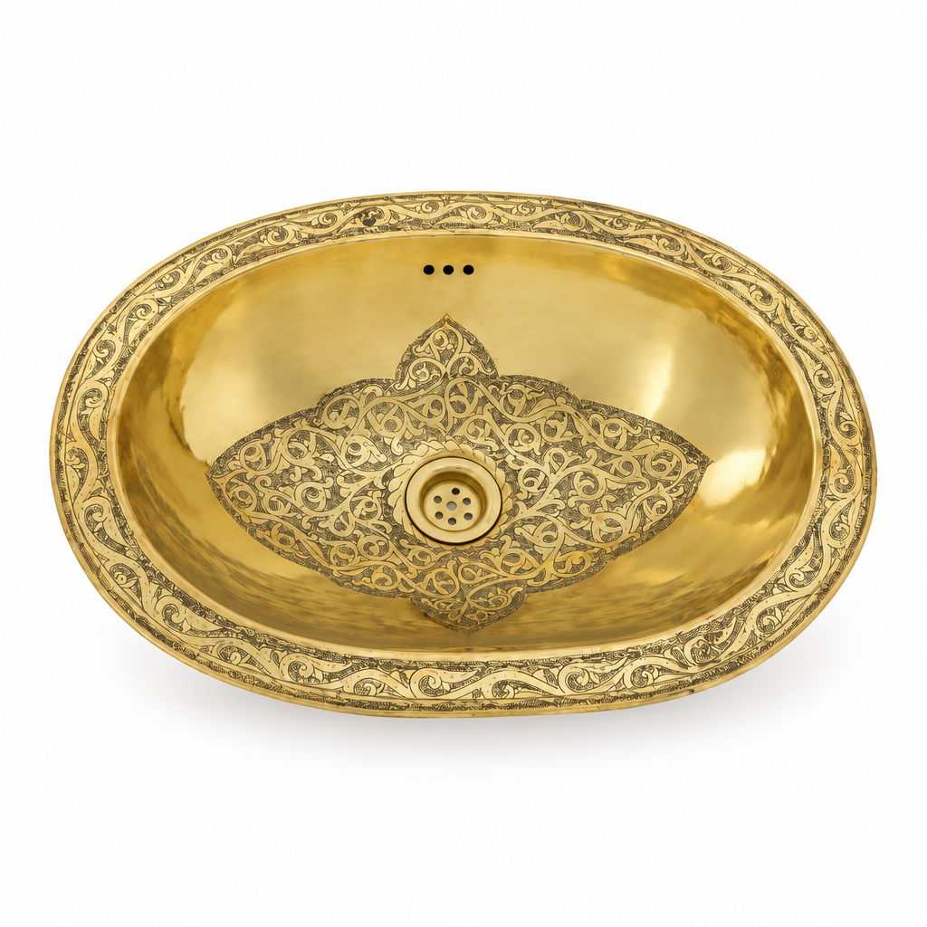 Engraved oval brass drop-in sink on a white background