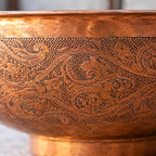 Close-up of the hand-engraved floral and paisley band on the copper bowl