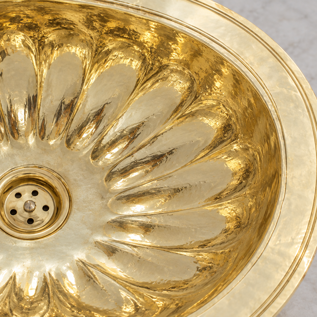 Close-up of the fluted petal oval brass drop-in sink showing the finish