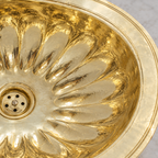 Close-up of the fluted petal oval brass drop-in sink showing the finish