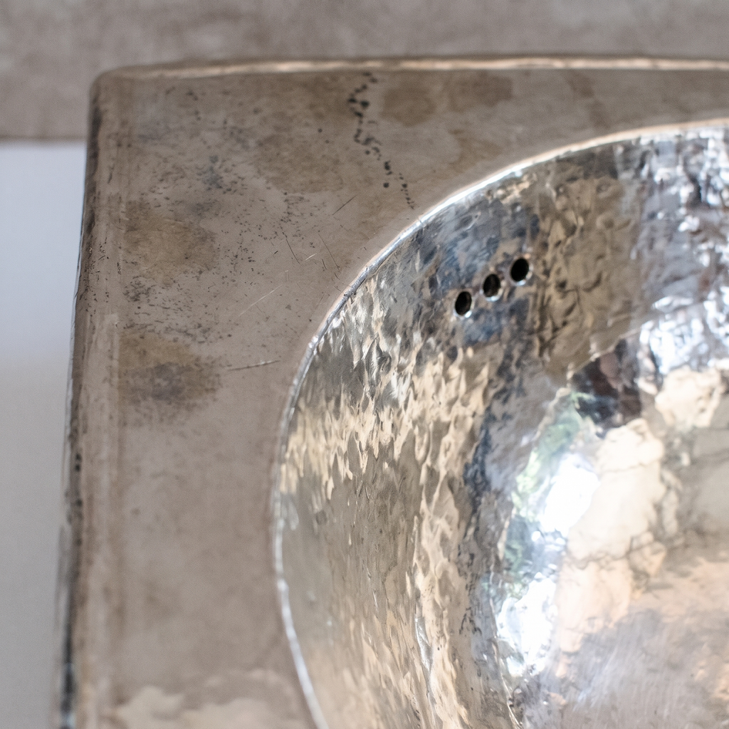 Close-up of the hand-hammered German silver bowl and overflow holes