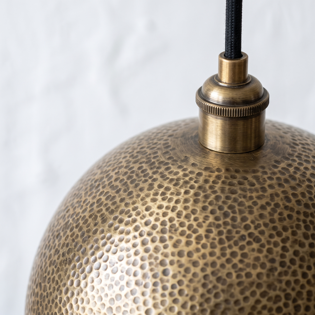 Round hammered dimples and ridged brass socket cup of the globe pendant