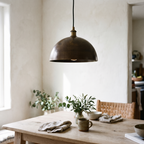 Hammered antique bronze dome pendant over a white oak breakfast table