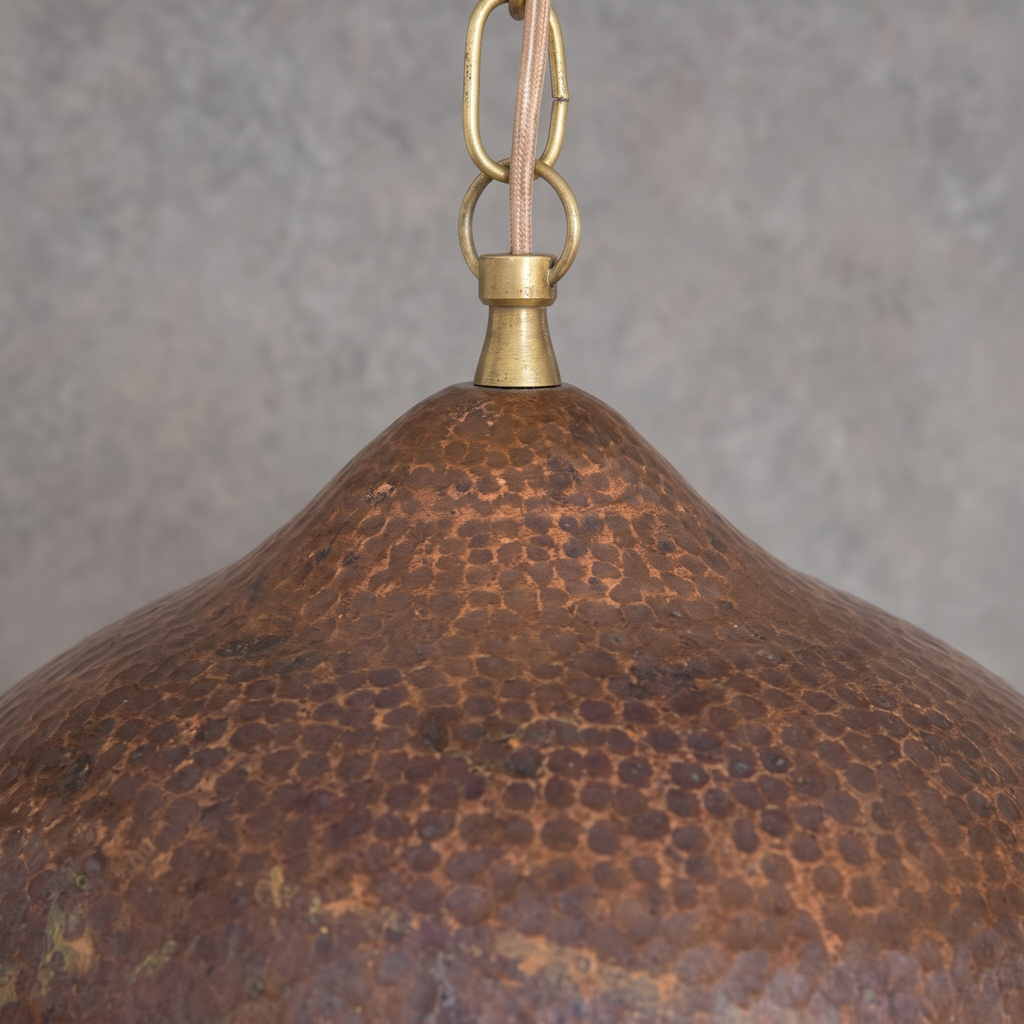 Close-up of the hammered antique copper shade and brass neck
