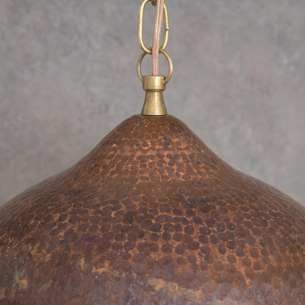 Close-up of the hammered antique copper shade and brass neck