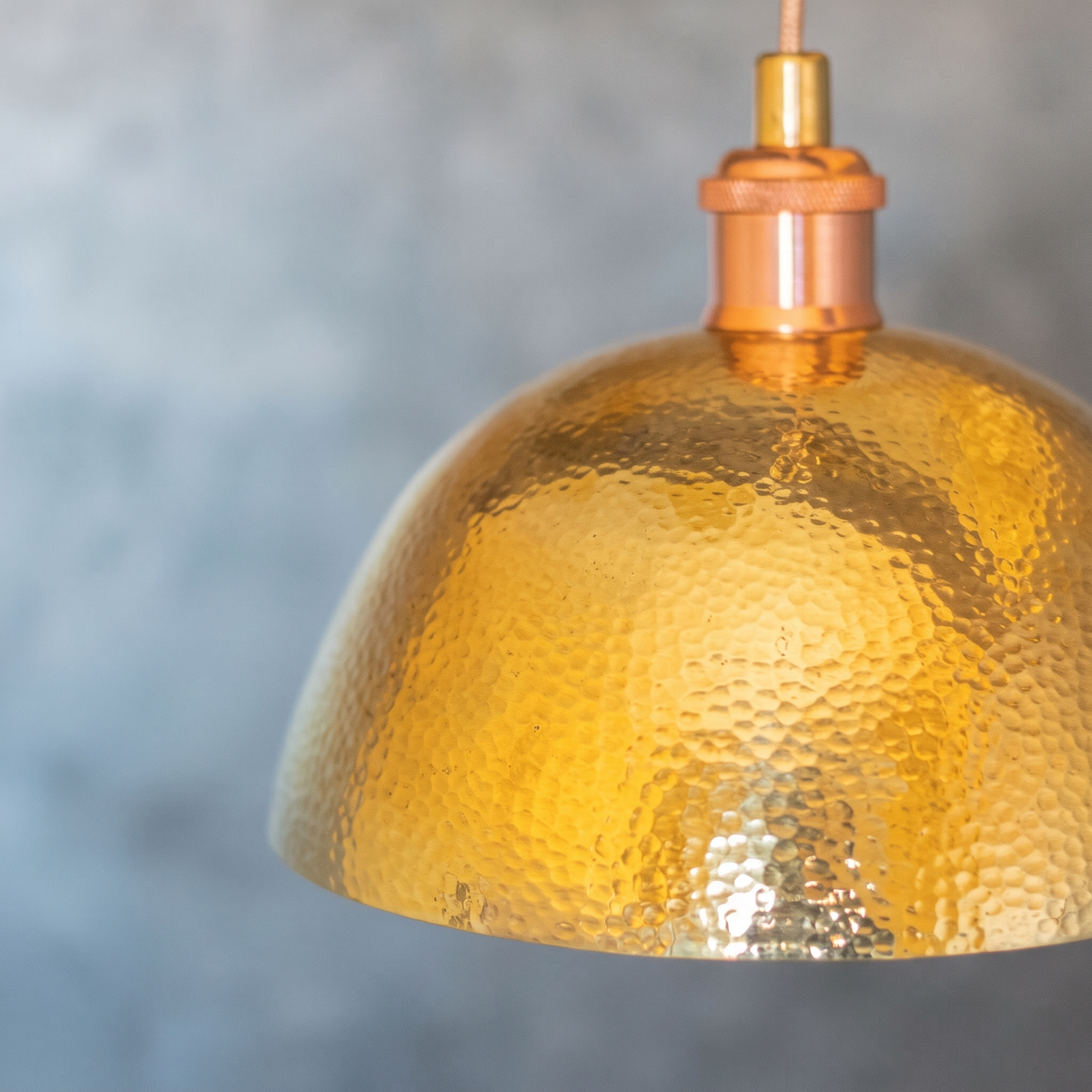 Close-up of the fine hand-hammered texture of the unlacquered brass dome