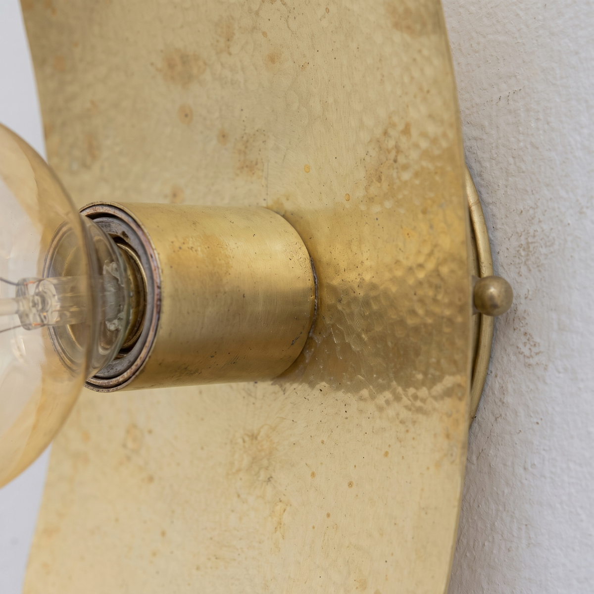 Close-up of the softly hammered unlacquered brass plate and socket