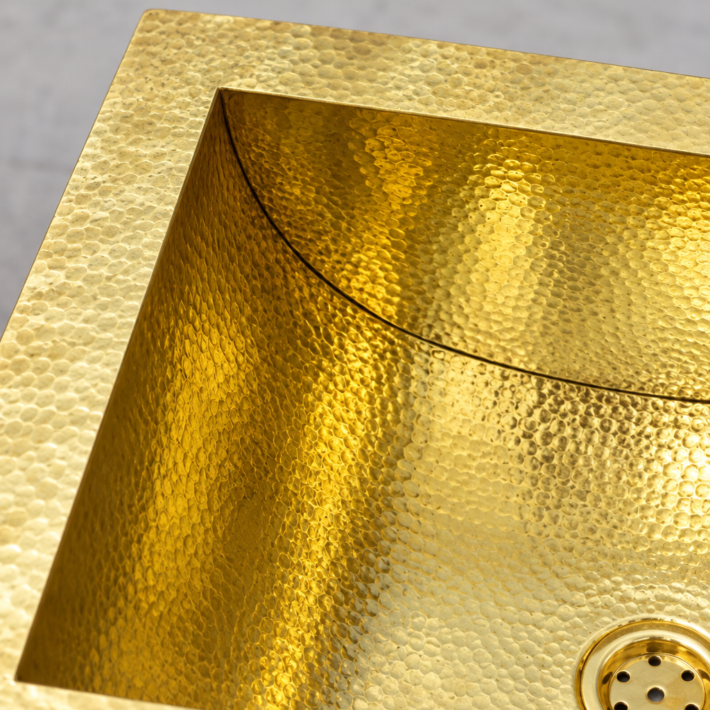 Close-up of the flat flange and hand-hammered curved brass wall