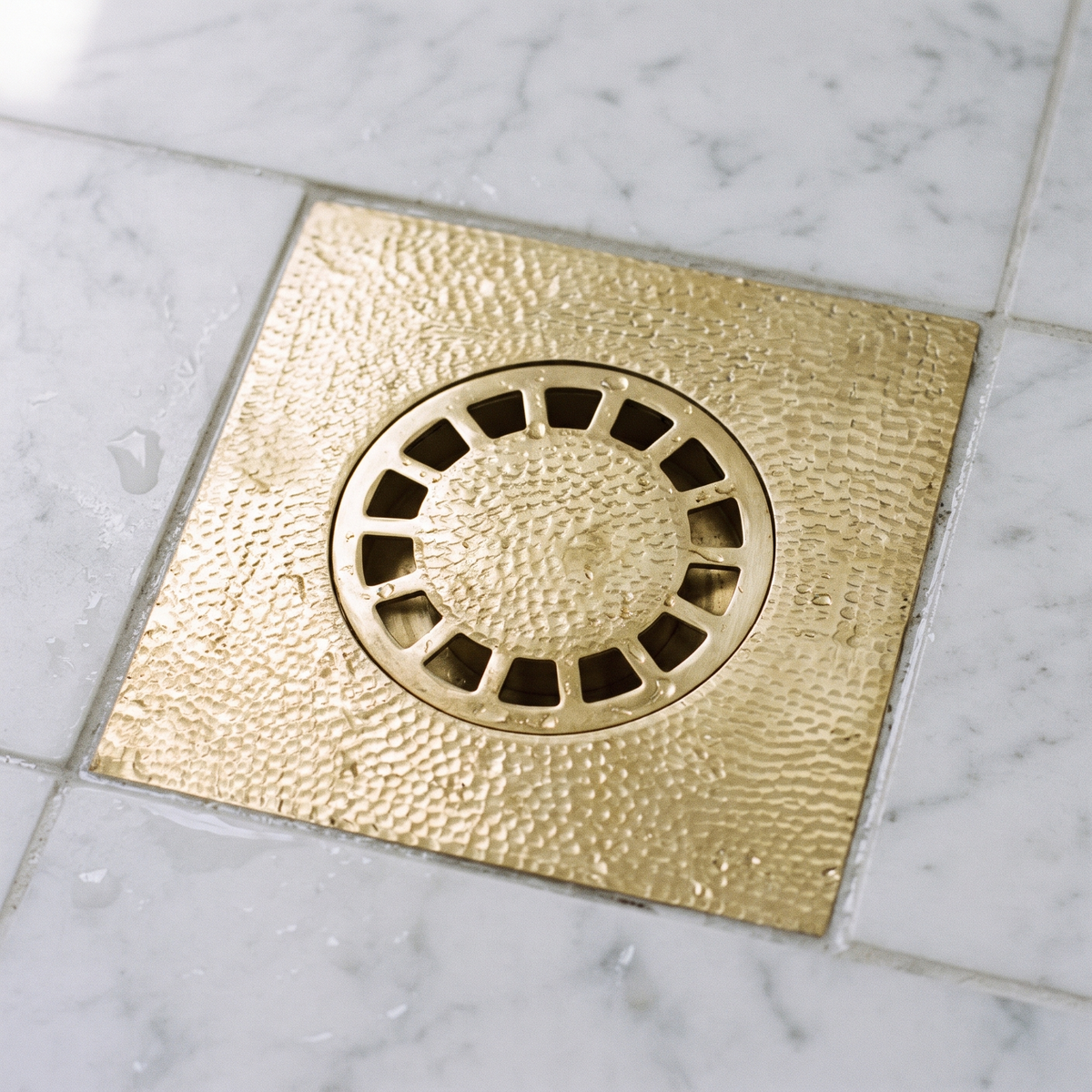 Close view of the hand-hammered brass texture and grate slots