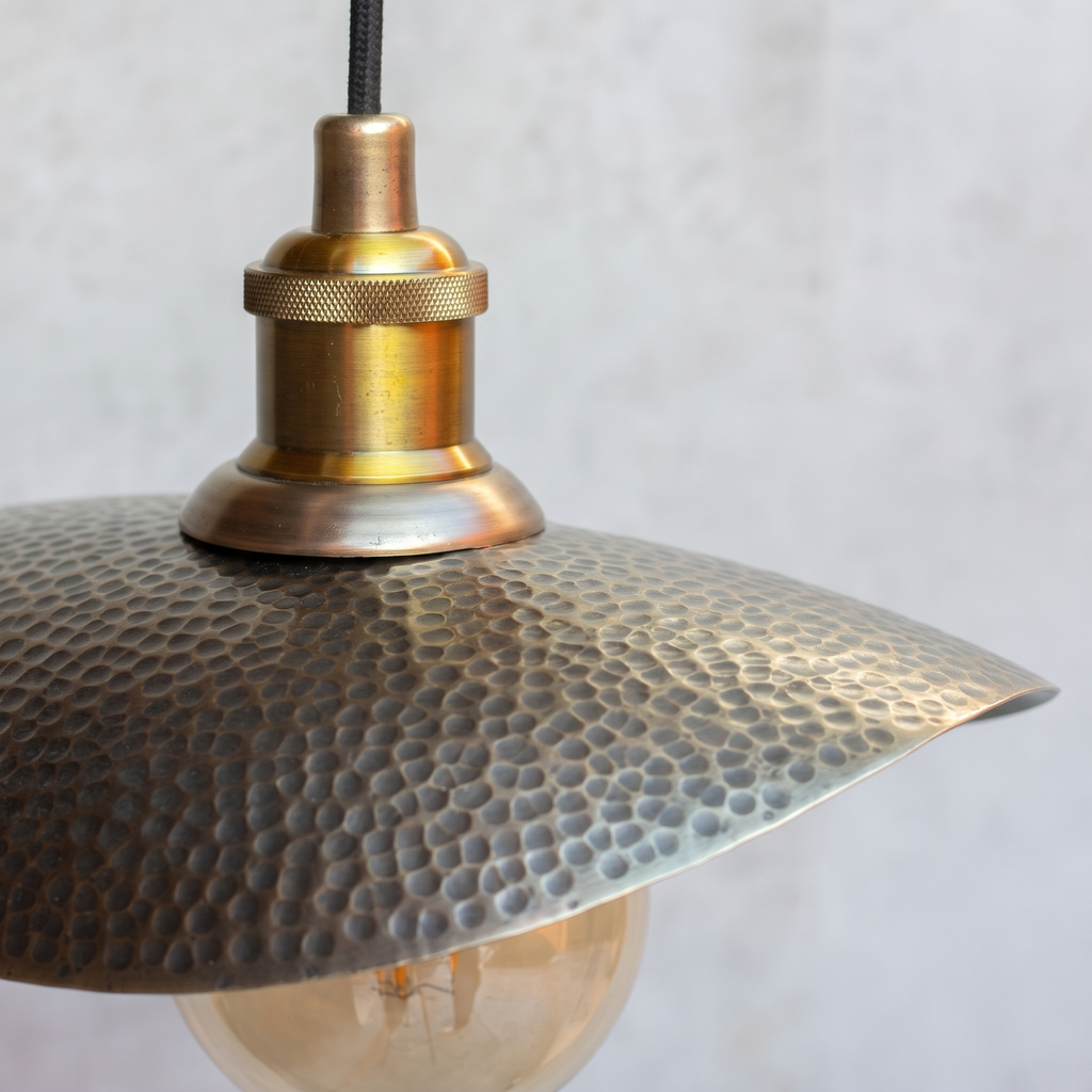 Close-up of the hammered bronze finish plate and knurled brass socket