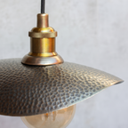 Close-up of the hammered bronze finish plate and knurled brass socket