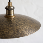 Pebbled hammered texture and antique brass socket of the saucer pendant
