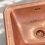 Hammered Copper Drop-In Bathroom Sink close-up of the rim, overflow and hammered copper