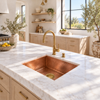 Bright California kitchen with a hammered copper square sink and brass basket strainer