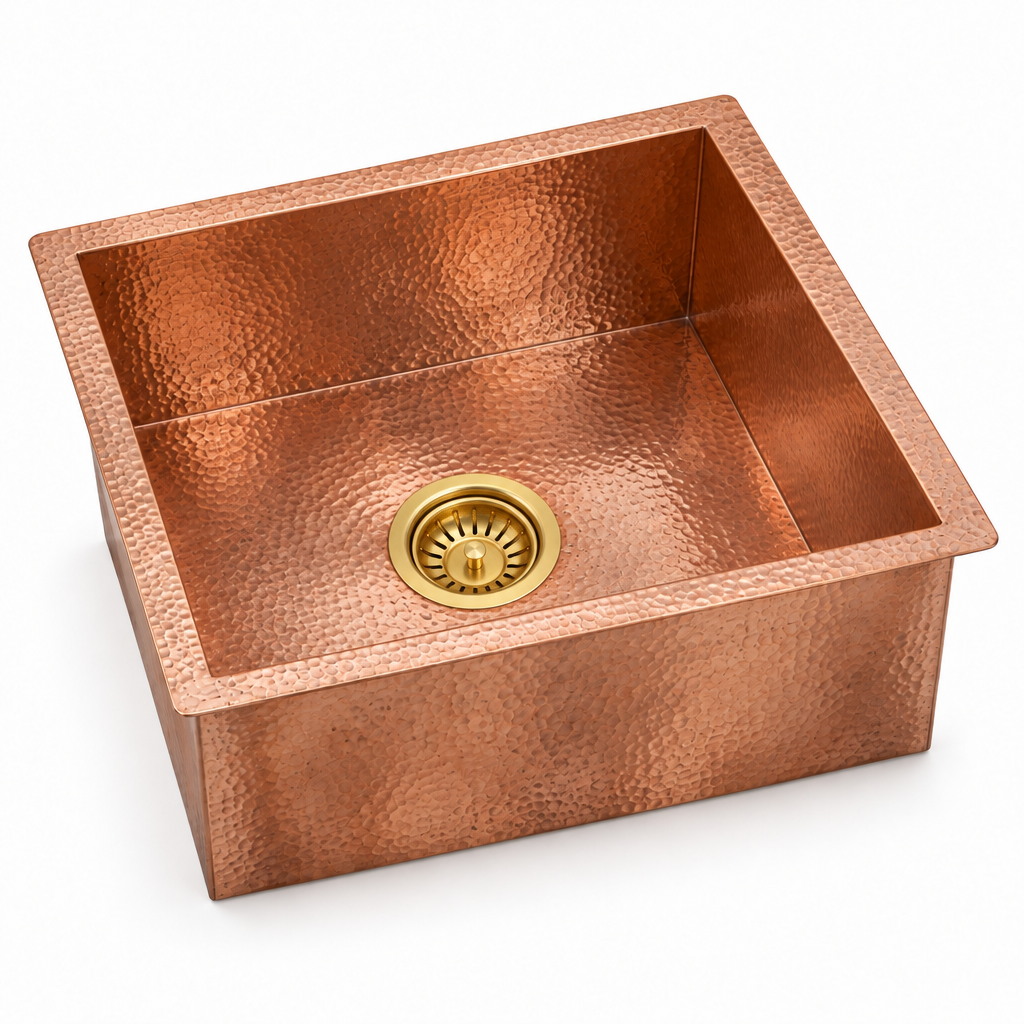 Hammered copper square undermount sink with included brass basket strainer on a white background
