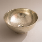 Deep hammered German silver vessel bowl with flared rim and low foot on a plain background