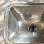 Close-up of the hand-hammered German silver interior and narrow rim