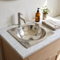 Hammered German silver square drop-in sink in a white marble bathroom vanity