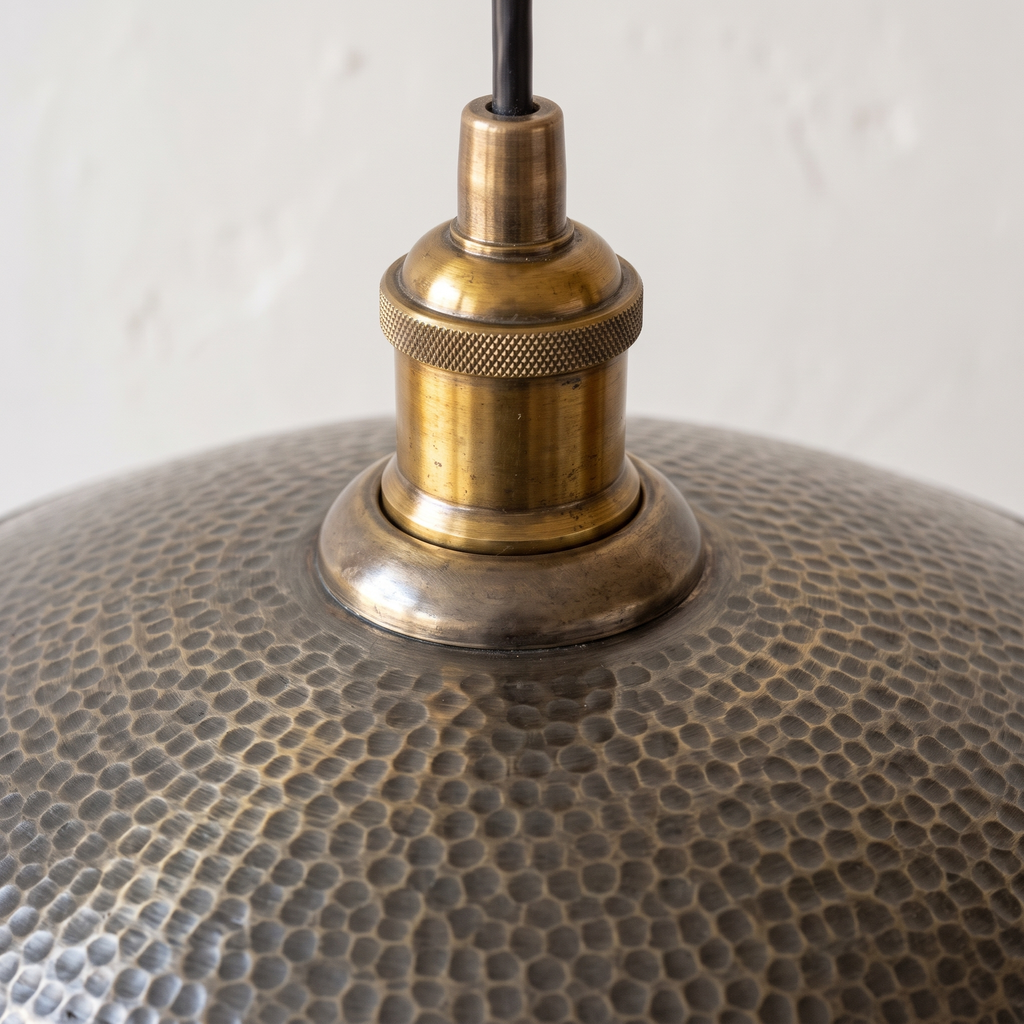 Close-up of the hand-hammered grey bronze texture and brass socket