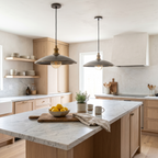 Two hammered grey bronze saucer pendant lights over a white marble kitchen island