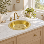Hammered Oval Brass Drop-In Sink with Overflow in a bright, airy bathroom