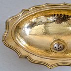 Close-up of the scalloped stepped rim and hammered brass bowl