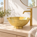 Hammered Oval Brass Vessel Sink on a pedestal foot in a bright, sunlit California bathroom