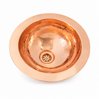 Hammered round copper undermount sink on a white background