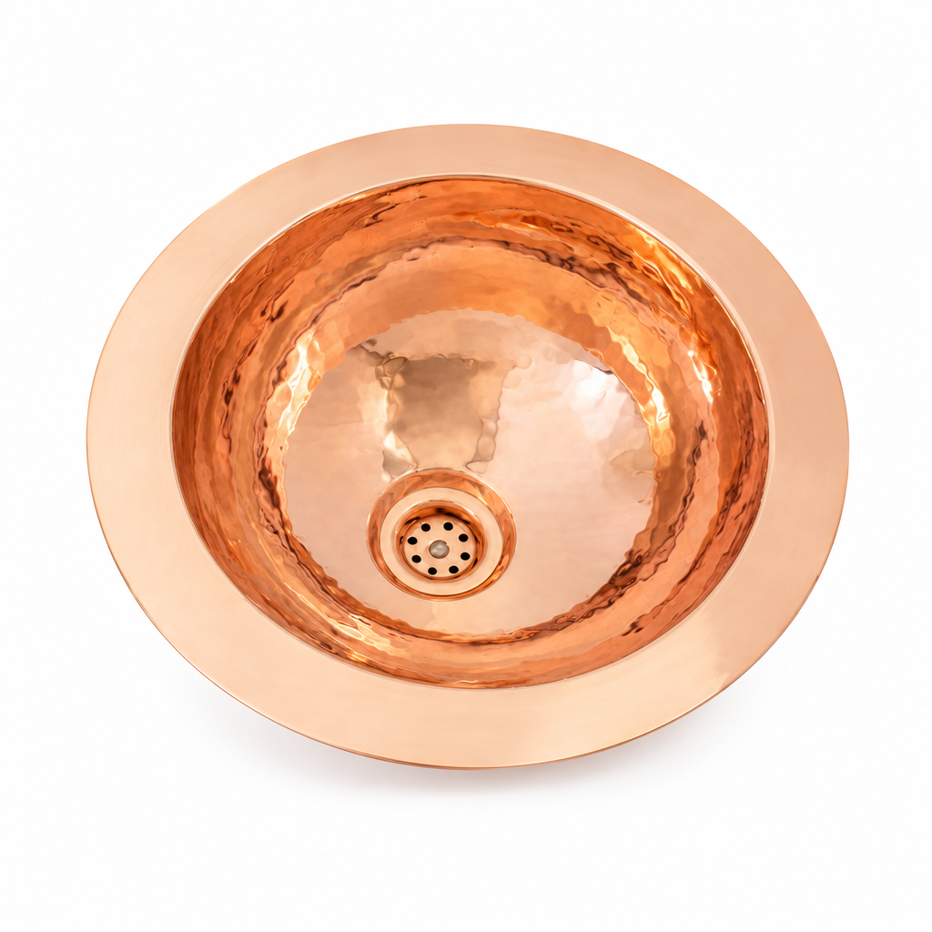 Hammered round copper undermount sink on a white background
