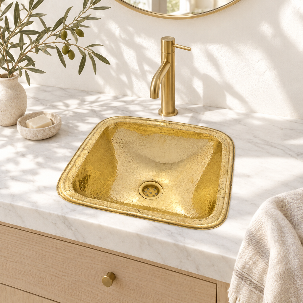 Hammered Square Brass Drop-In Bathroom Sink in a white marble vanity in a bright California bathroom