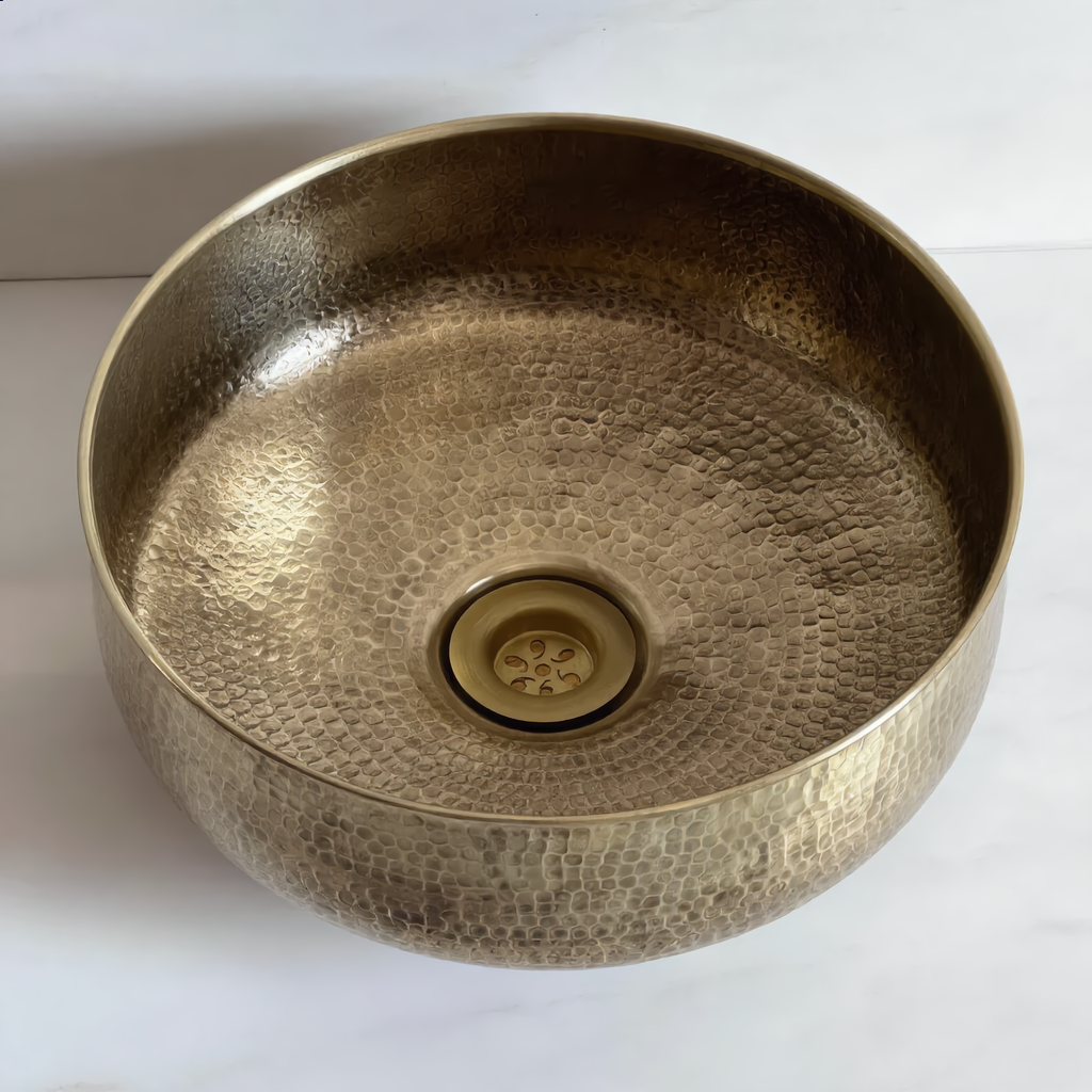 Top-down view of the brass vessel sink with its brass drain
