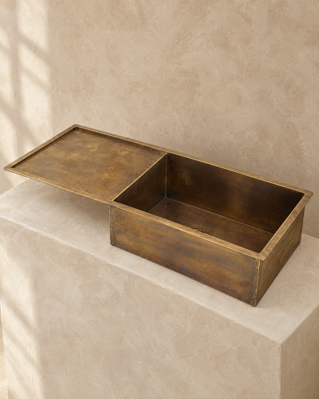 Brass kitchen sink with drainboard, three quarter view
