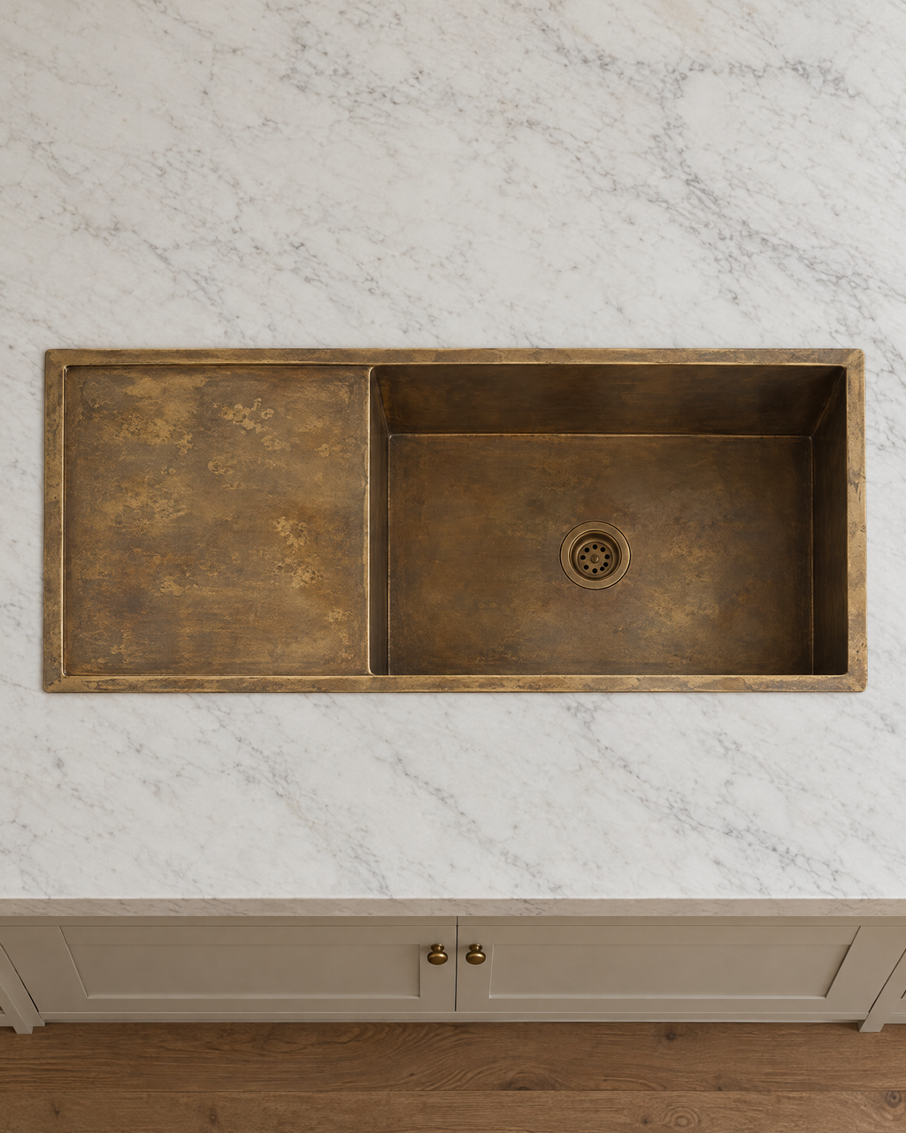 Overhead view of a brass kitchen sink with drainboard