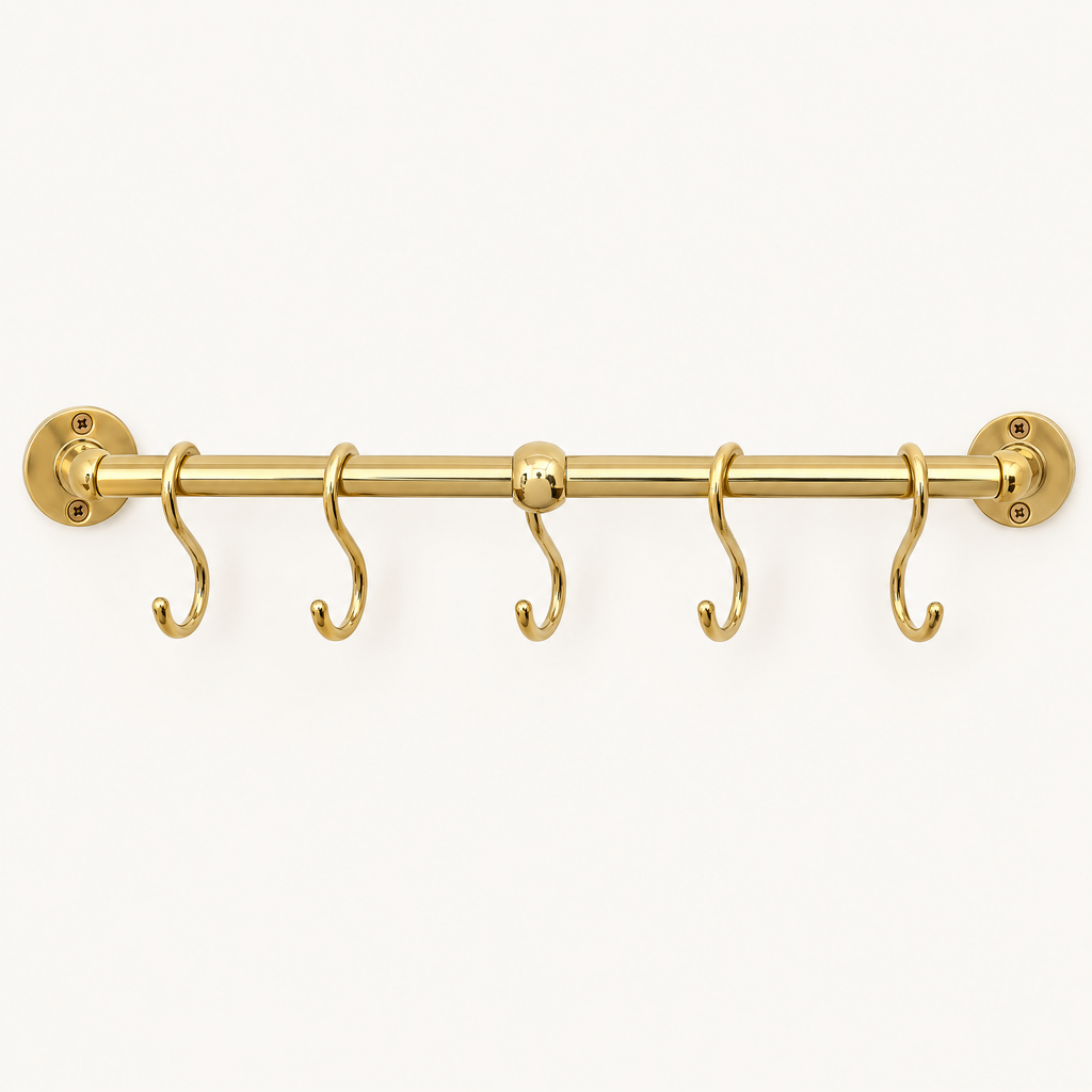 Handmade unlacquered brass kitchen pot rail with S hooks on a white background