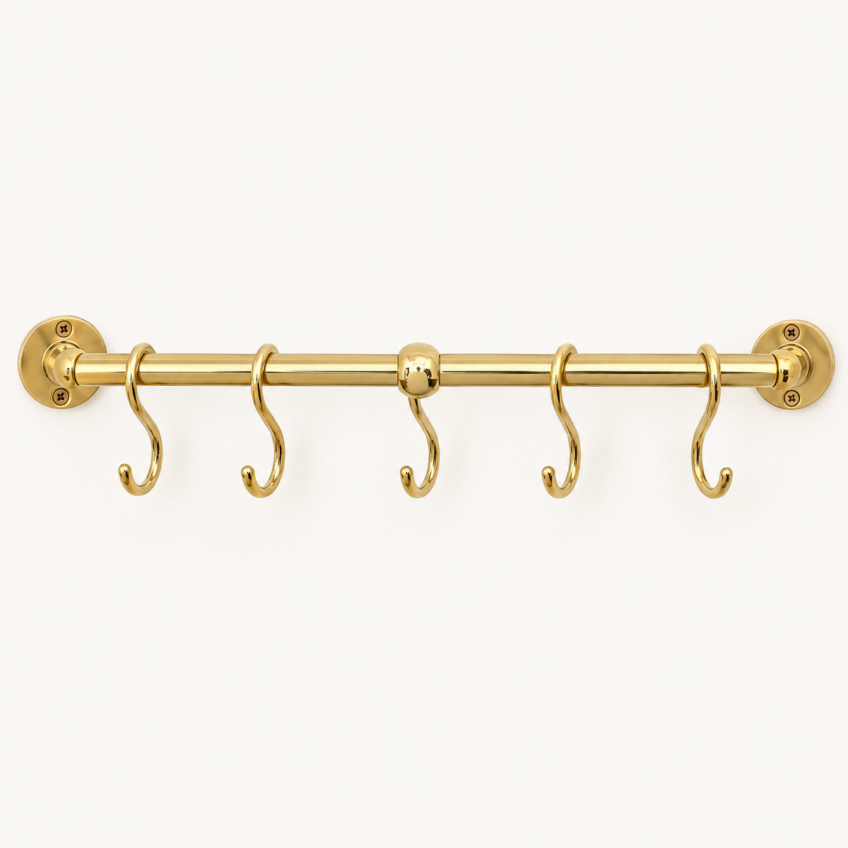 Handmade unlacquered brass kitchen pot rail with S hooks on a white background